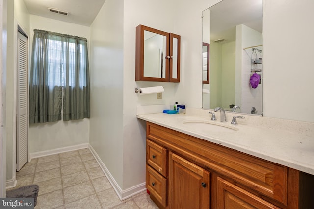 bathroom with vanity and tile floors