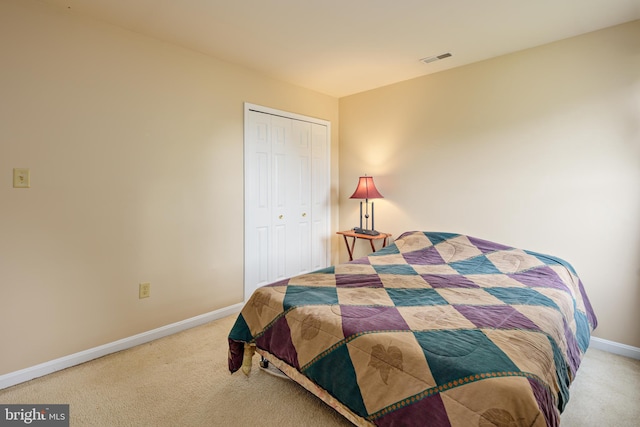 bedroom with carpet and a closet