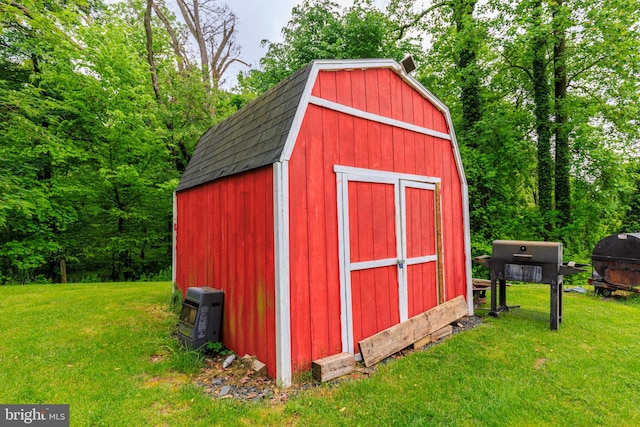 view of outdoor structure featuring a lawn