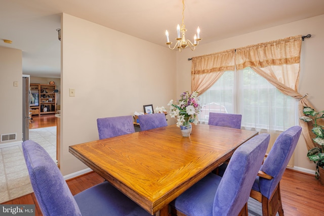 dining room featuring a chandelier and hardwood / wood-style floors