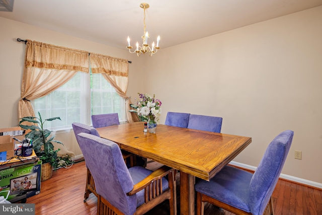 dining space with an inviting chandelier and hardwood / wood-style floors