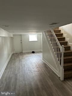 basement with hardwood / wood-style floors