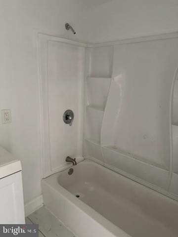 bathroom with tile flooring, vanity, and  shower combination