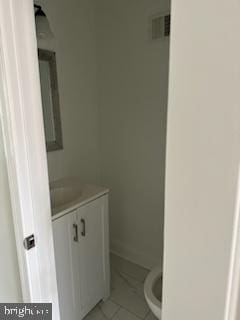 bathroom with tile floors, toilet, and vanity