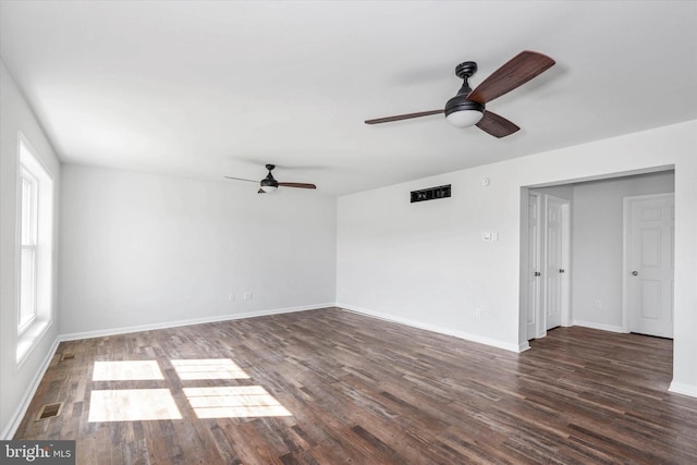 unfurnished room with ceiling fan and dark wood-type flooring