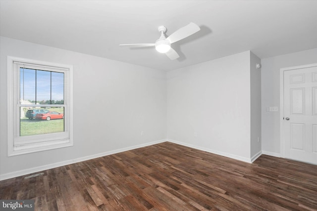 spare room featuring dark hardwood / wood-style flooring and ceiling fan