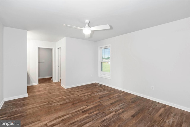 empty room with dark hardwood / wood-style floors and ceiling fan