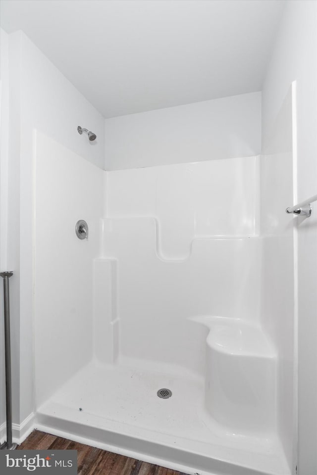 bathroom featuring hardwood / wood-style flooring and walk in shower