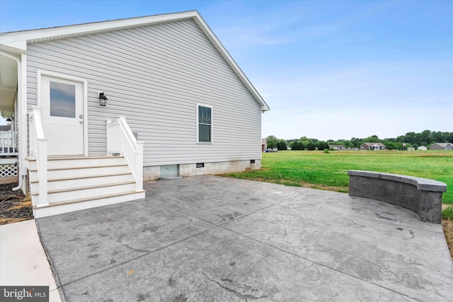 rear view of property featuring a yard and a patio