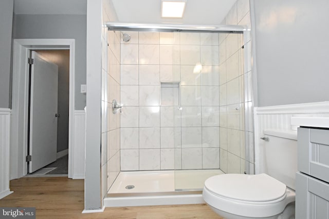 bathroom with an enclosed shower, hardwood / wood-style floors, toilet, and vanity