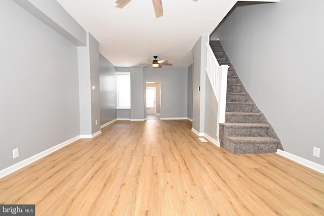 unfurnished living room featuring light hardwood / wood-style floors and ceiling fan