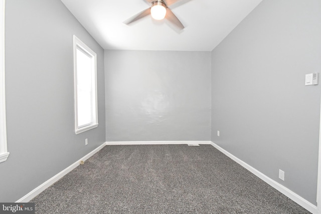 carpeted spare room with ceiling fan