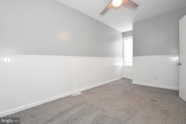 carpeted empty room featuring lofted ceiling and ceiling fan