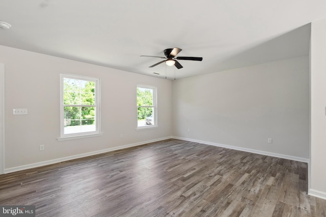 empty room featuring hardwood / wood-style floors and ceiling fan