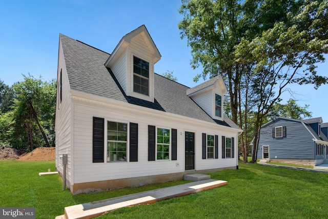 new england style home featuring a front lawn