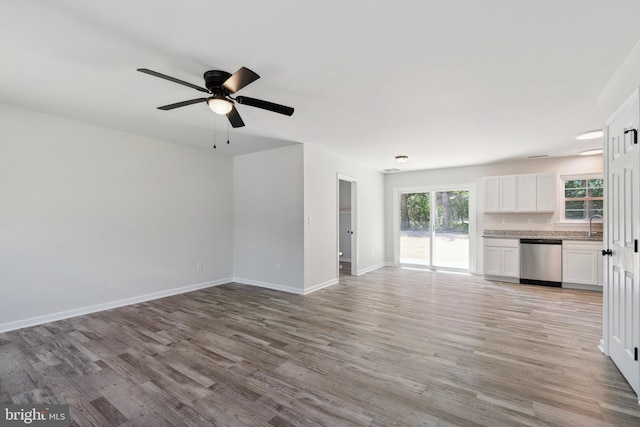 unfurnished living room featuring ceiling fan and light hardwood / wood-style floors