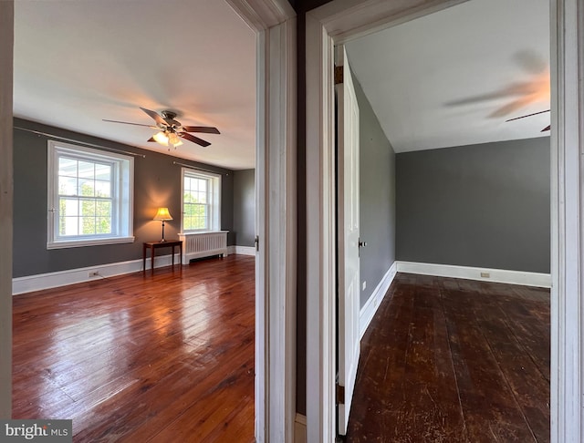 hall featuring radiator, lofted ceiling, and dark hardwood / wood-style flooring