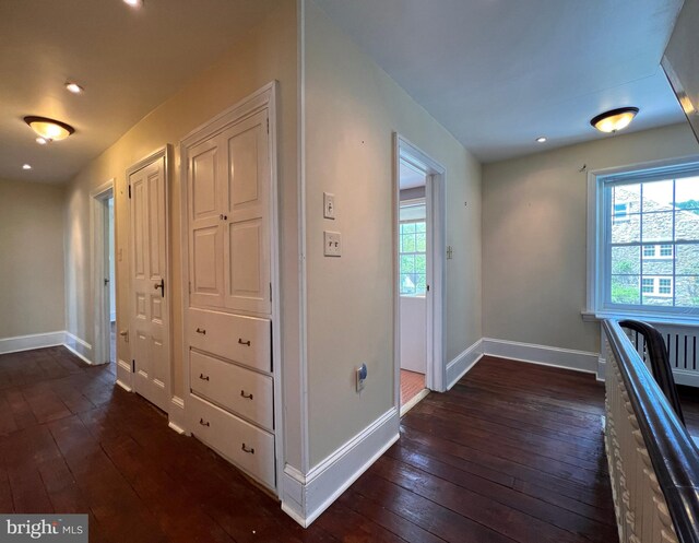 corridor featuring dark hardwood / wood-style floors