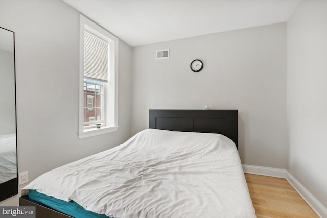 bedroom with hardwood / wood-style floors