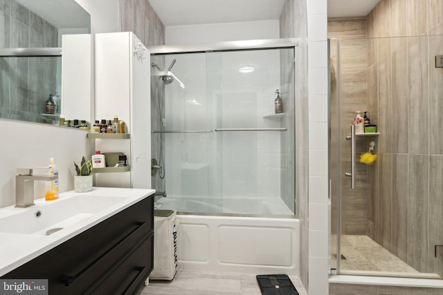 bathroom with vanity and enclosed tub / shower combo