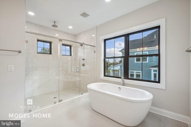 bathroom with tile patterned floors, plus walk in shower, and a wealth of natural light