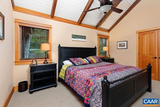 carpeted bedroom with lofted ceiling with beams and ceiling fan