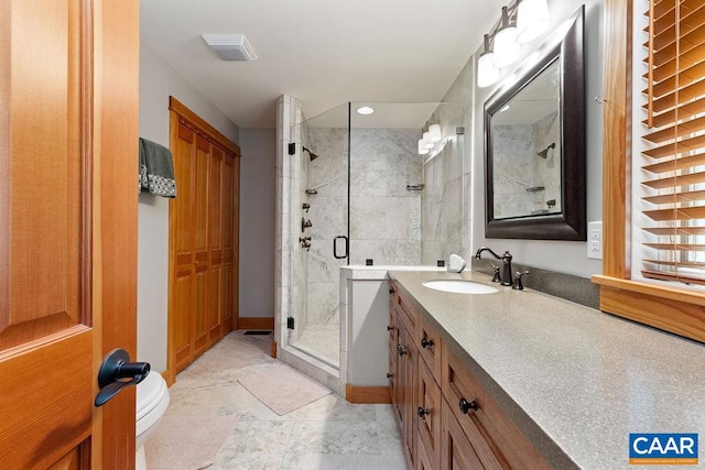 bathroom featuring an enclosed shower, tile flooring, large vanity, and toilet