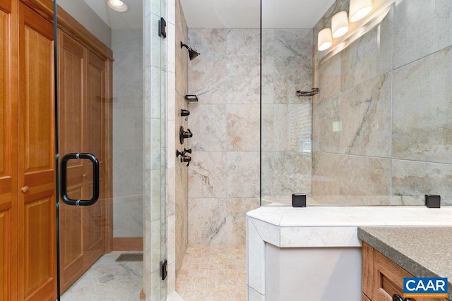 bathroom with a shower with door and vanity