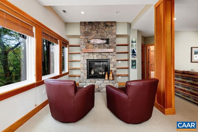 living room featuring carpet and a fireplace