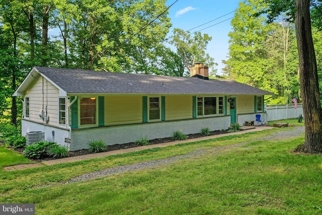 ranch-style home featuring a front yard and central air condition unit