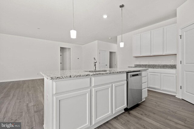 kitchen with a center island with sink, pendant lighting, white cabinetry, and sink