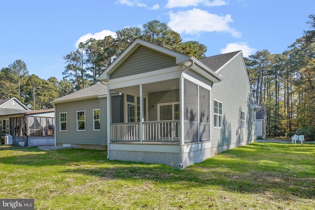 view of front of property with a front lawn and a sunroom