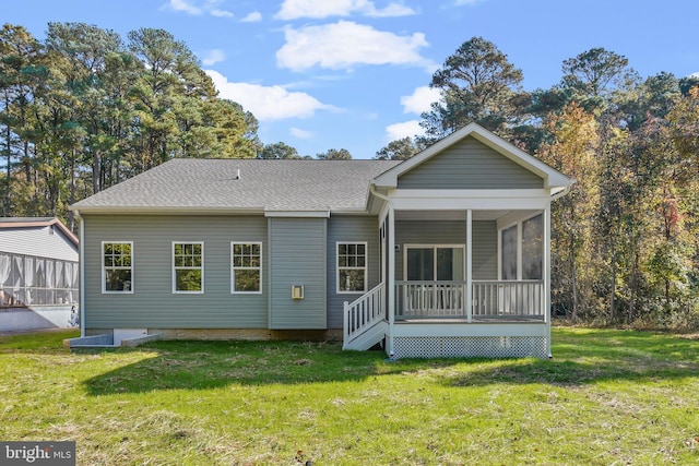 back of house with a sunroom and a yard