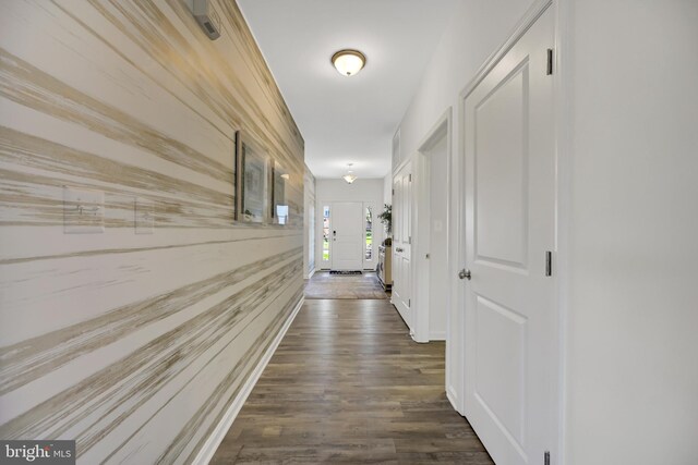 corridor with dark hardwood / wood-style flooring