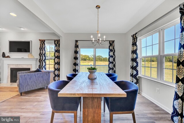 dining space featuring hardwood / wood-style flooring and a notable chandelier