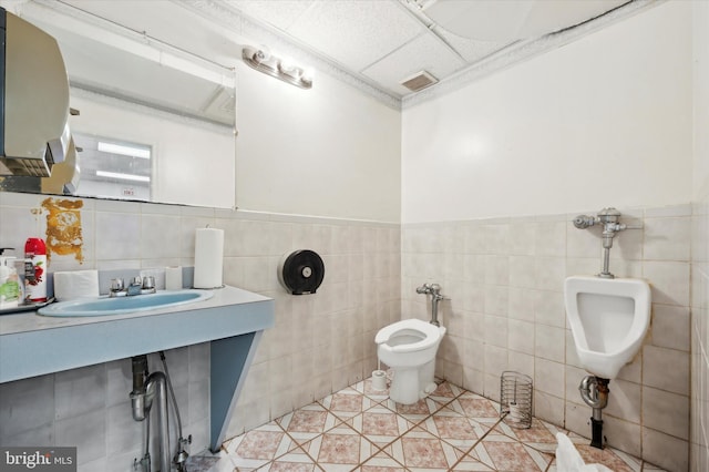 bathroom featuring a bidet, tile walls, tile floors, sink, and toilet