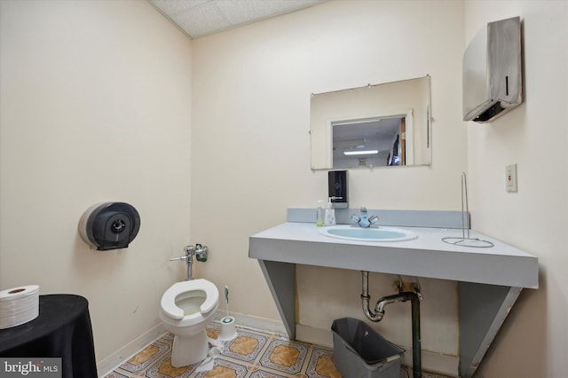 bathroom with sink, toilet, and tile floors