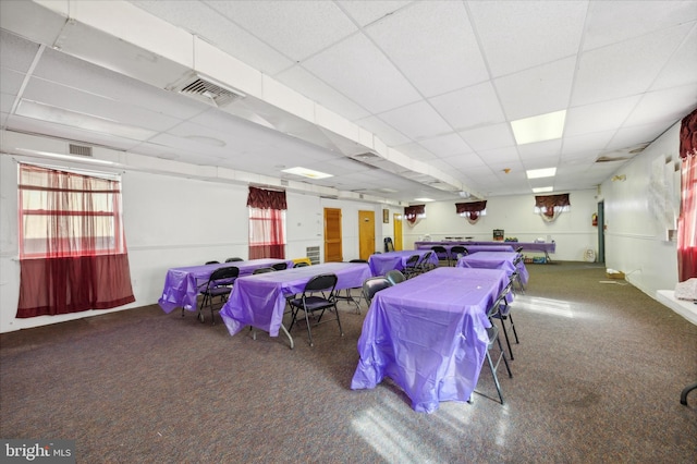 interior space with a paneled ceiling