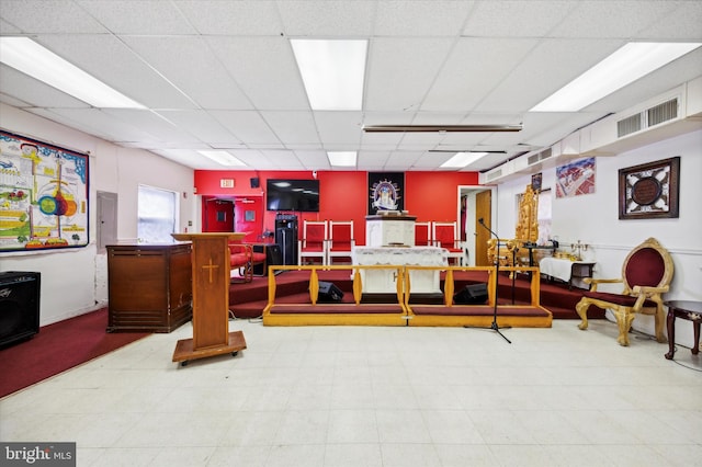 interior space with tile floors and a drop ceiling