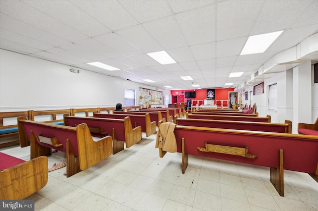 misc room featuring tile flooring and a paneled ceiling