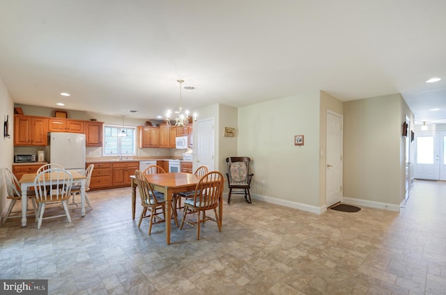 dining room featuring a notable chandelier and sink