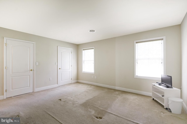 interior space featuring light carpet