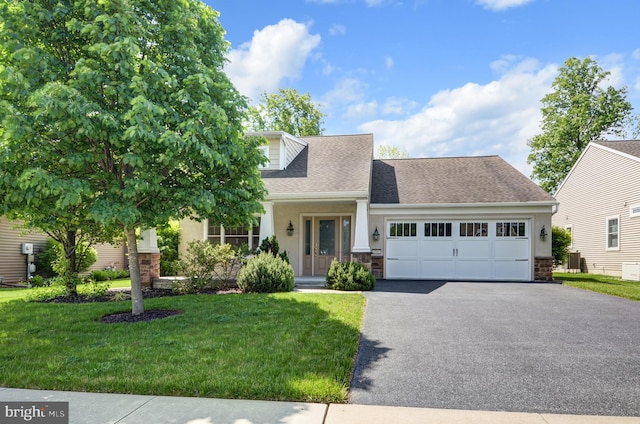 new england style home with a garage and a front lawn