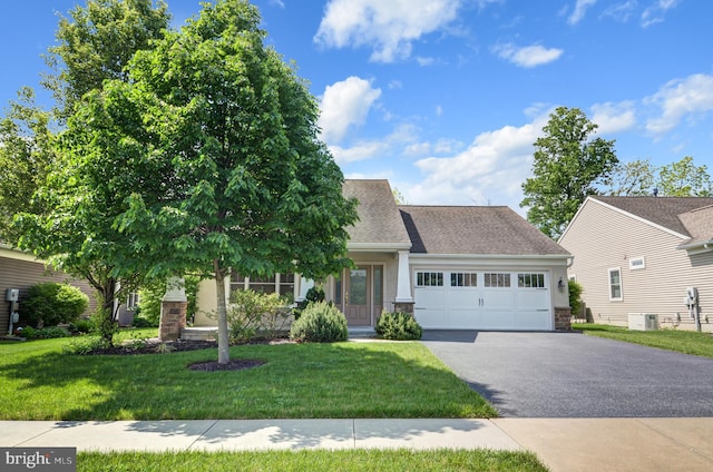 view of front facade featuring central AC unit, a garage, and a front lawn