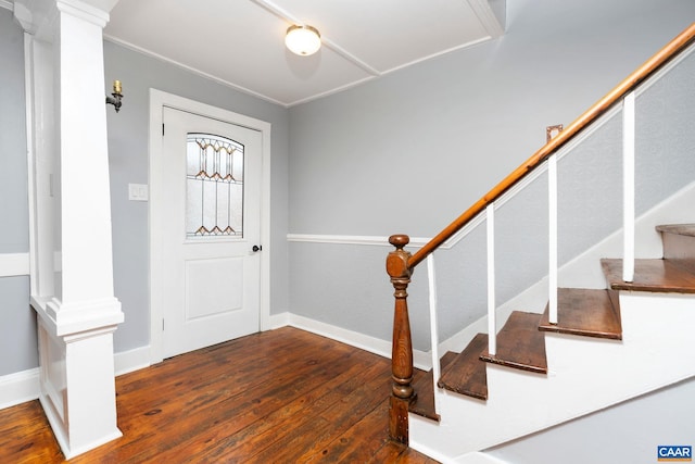 entryway featuring dark hardwood / wood-style floors, ornate columns, and crown molding