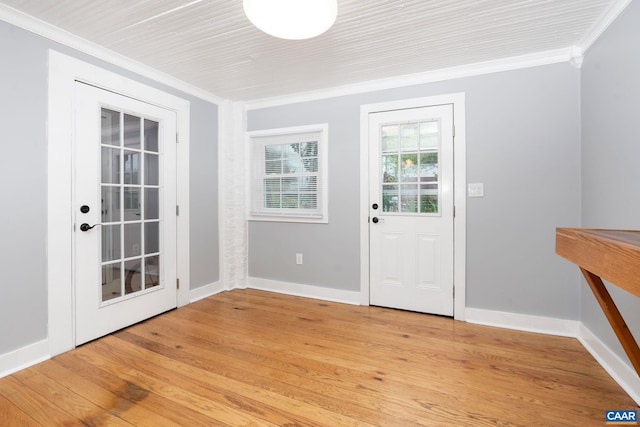 entryway with ornamental molding and light wood-type flooring