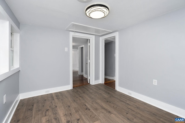 unfurnished room featuring dark hardwood / wood-style flooring