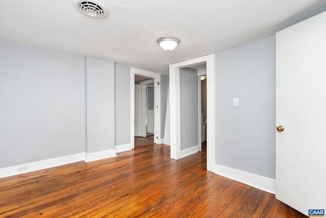 spare room featuring dark wood-type flooring