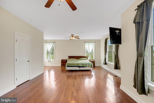 bedroom with wood-type flooring and ceiling fan