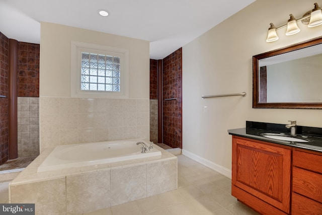 bathroom with vanity, tile patterned floors, and tiled tub